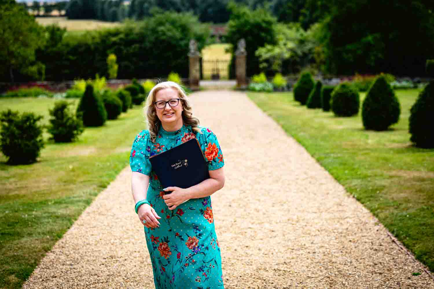 Deb Reed Celebrant Essex Colchester posing with arms out smiling.